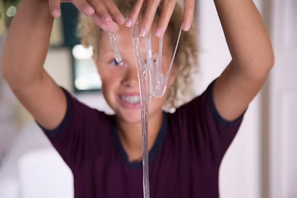 Child participating in sensory play during occupational therapy