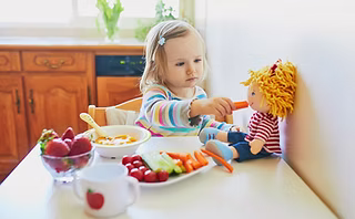Child exploring new foods through play during feeding therapy