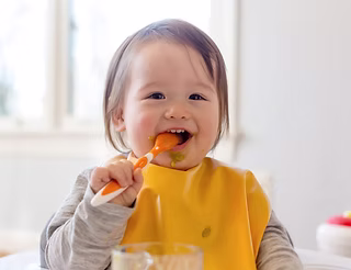 Child eating solid foods during feeding therapy