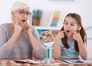 Child in speech therapy working on articulation skills
