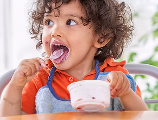 Child in feeding therapy working on swallow skills